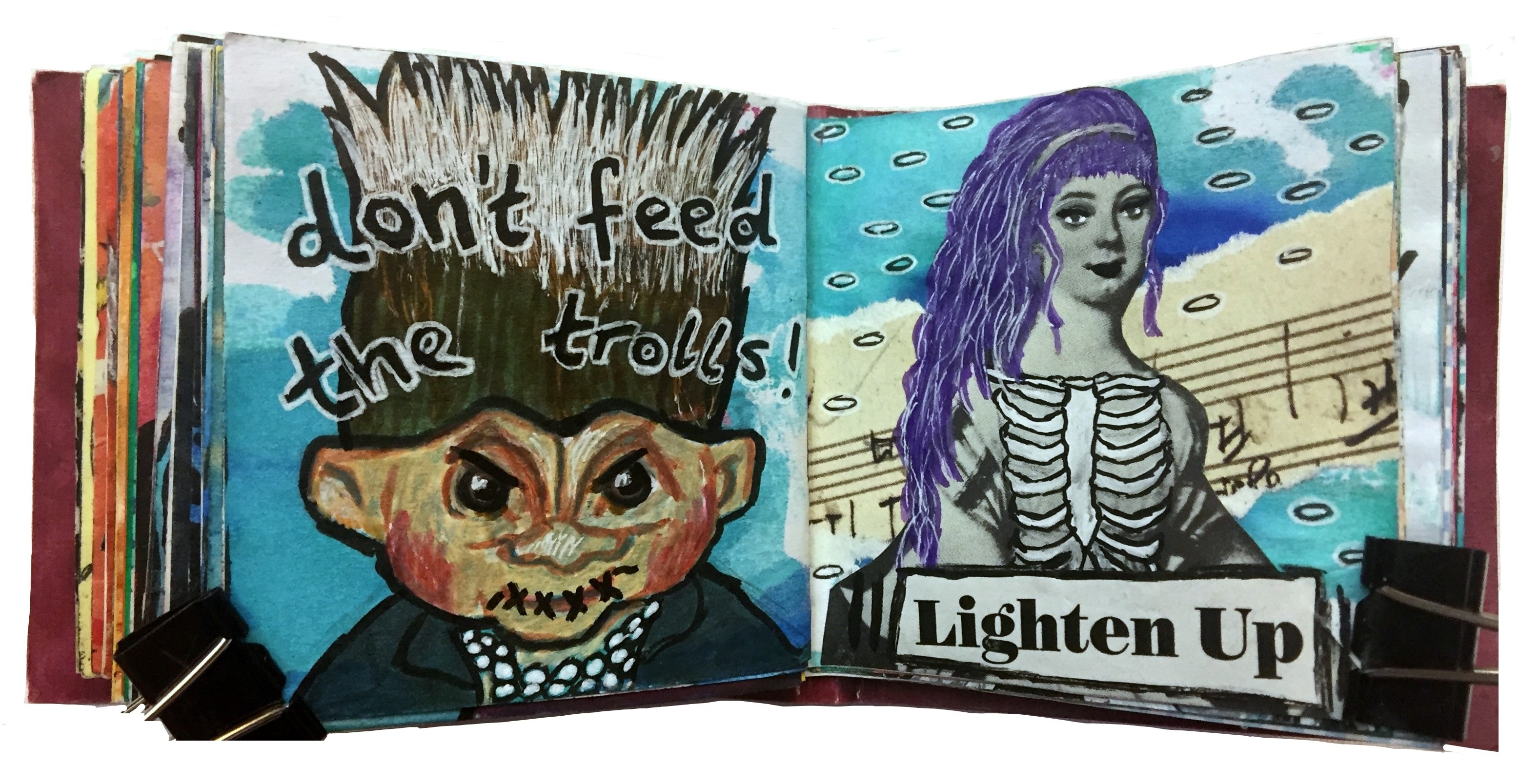 Days 56 and 57/365 of Year of Creative Habits. A mixed media art journal illustration of a troll with its mouth stitched shut with the words don’t feed the trolls and a collaged woman with purple hair and ribs exposed saying lighten up.